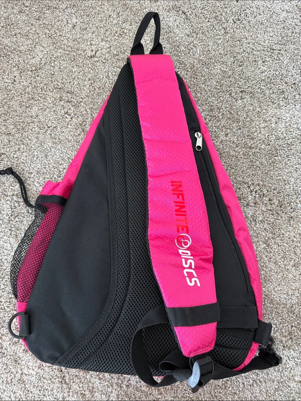 Bright Pink Sling Backpack with Black Mesh Pocket